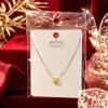 A golden cylindrical small diamond pendant necklace with a white card attached to a transparent bag Specification image